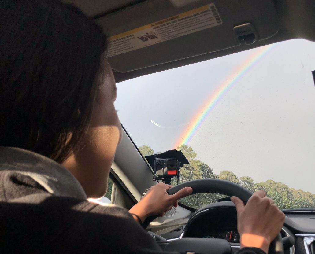 Manal al-Sharif driving to New Orleans with a rainbow in the distance. (photo credit: Jim Warnock)